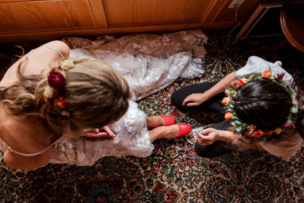 Top down view of bride and bridesmaid during candid getting ready moment