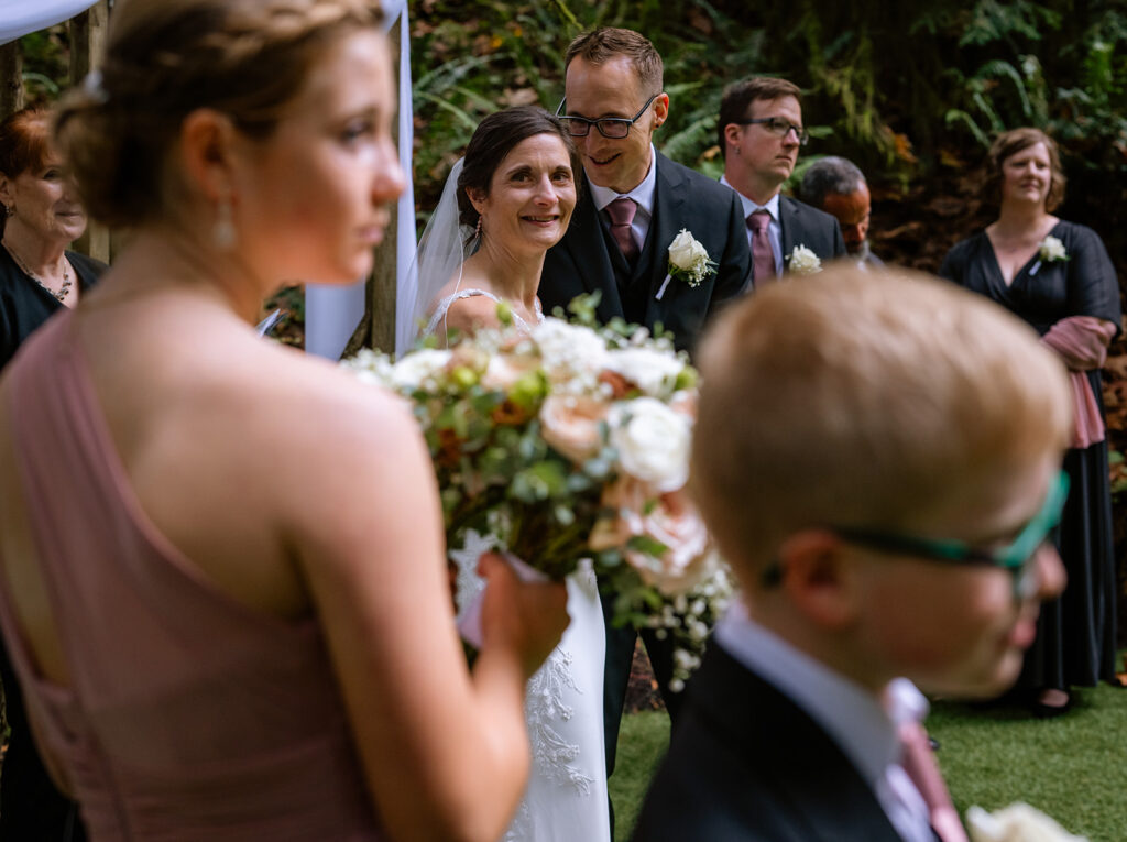 Bride looks at her kids as she stands at the alter