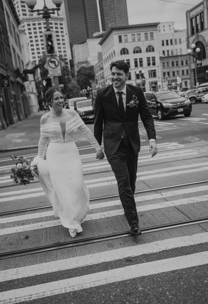 Bridal Couple crosses at a crosswalk during couples photos at europa wedding 