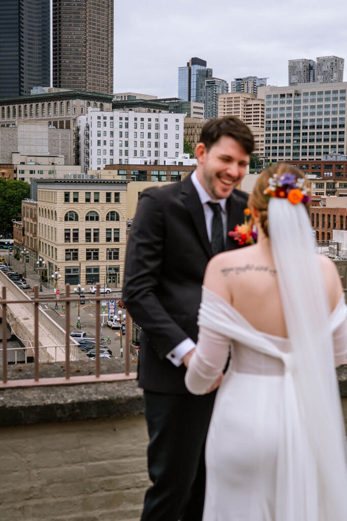 Groom and bride have first look at rooftop at Europa venue in seattle