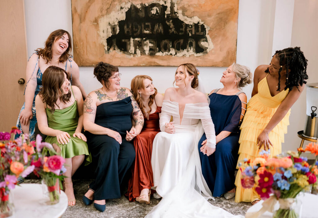Bride and bridesmaids pose for a group photo in getting ready suite at europa venue in seattle