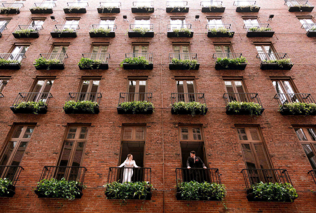 iconic balcony shot of bride and groom for their europa wedding seattle